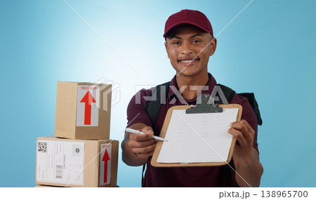 Delivery man, boxes and document for signature, distribution or courier service checklist on a blue background. Portrait of logistics worker with package and receipt or clipboard paperwork in studio 138965700