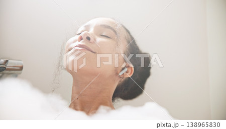 Music, face or happy woman in a bath in hotel cleaning, grooming or body care in soap foam. Relax, earphones or calm lady lying in water in spa, home or bathroom streaming or listening to radio song 138965830