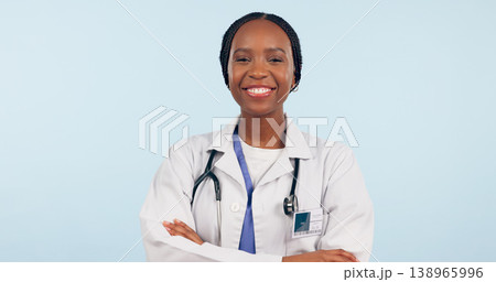 Happy black woman, portrait and professional doctor with arms crossed on a studio blue background. Face of African female person, surgeon or medical nurse smile in confidence for healthcare on mockup Happy black woman, portrait and professional doctor with arms crossed on a studio blue background. Face of African female person, surgeon or medical nurse smile in confidence for healthcare on mockup 138965996