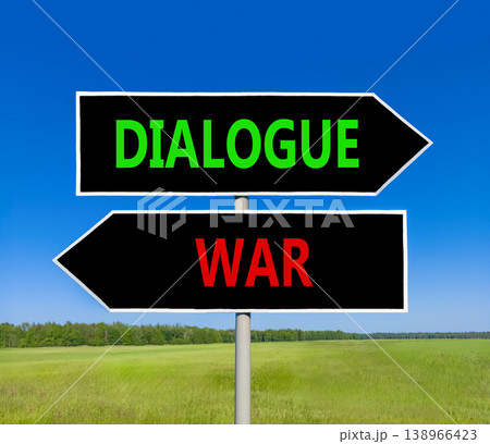 Dialogue instead war symbol. Concept words Dialogue and War on beautiful black road sign. Beautiful blue sky green grass background. Social and dialogue instead war concept. Copy space. 138966423