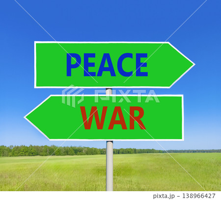 Peace instead war symbol. Concept words Peace and War on beautiful green road sign. Beautiful blue sky green grass background. Social and peace instead war concept. Copy space. Peace instead war symbol. Concept words Peace and War on beautiful green road sign. Beautiful blue sky green grass background. Social and peace instead war concept. Copy space. 138966427