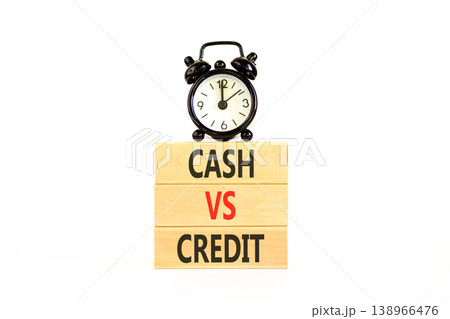 Cash vs credit words symbol. Concept words Cash vs credit on beautiful wooden blocks. Beautiful white background. Black alarm clock. Business and cash vs credit concept. Copy space. 138966476