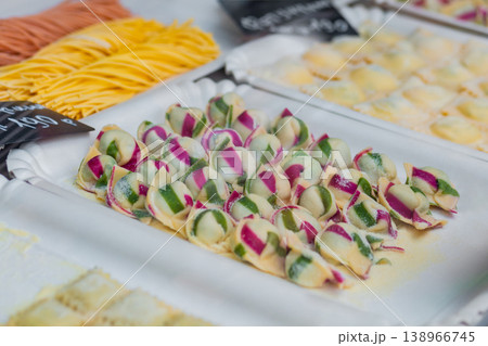 Raw homemade Italian ravioli pasta with meat and cheese on counter - close up Raw homemade Italian ravioli pasta with meat and cheese on counter - close up 138966745