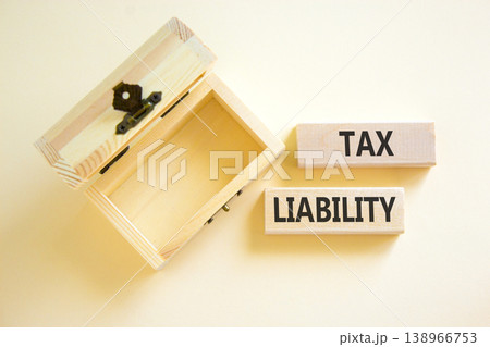 Tax liability words symbol. Concept words Tax liability on beautiful wooden blocks. Beautiful white background. Empty wooden chest. Business and Tax liability words concept. Copy space. 138966753