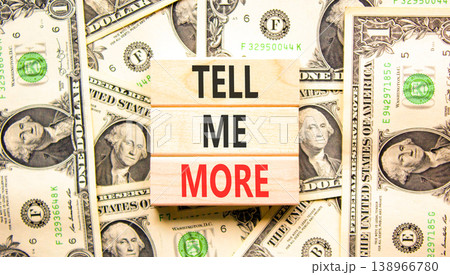Tell me more words symbol. Concept words Tell me more on beautiful wooden blocks. Beautiful dollar bills background. Dollar bills. Business and tell me more concept. Copy space. 138966780