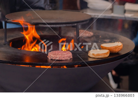 Process of grilling cutlet for burgers on brazier with hot flame Process of grilling cutlet for burgers on brazier with hot flame 138966803