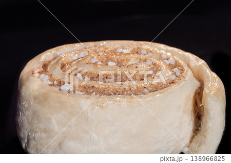 One uncooked cinnamon bun in electric oven, black background One uncooked cinnamon bun in electric oven, black background 138966825
