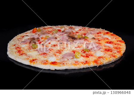 Uncooked homemade pizza on tray in electric oven, black background 138966848