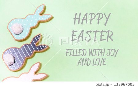 Green background with three Easter bunny cookies on it Green background with three Easter bunny cookies on it 138967003