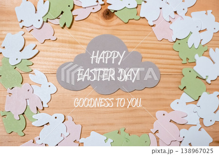 Wood grain background with a cloud and a bunch of Easter bunnies Wood grain background with a cloud and a bunch of Easter bunnies 138967025