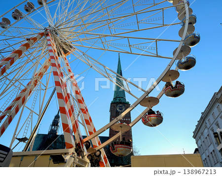Ferris wheel in city with church and blue sky 138967213