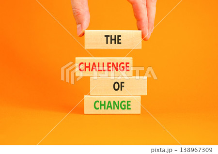 The challenge of change symbol. Concept words The challenge of change on beautiful wooden blocks. Beautiful orange background. Businessman hand. Business the challenge of change concept. Copy space. The challenge of change symbol. Concept words The challenge of change on beautiful wooden blocks. Beautiful orange background. Businessman hand. Business the challenge of change concept. Copy space. 138967309