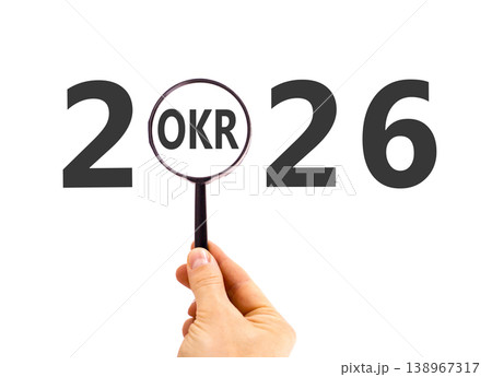 2026 OKR objectives and key results symbol. Concept words 2026 OKR in magnifying glass. Beautiful white background. Businessman's hand. Business 2026 OKR objectives and key results concept. Copy space 2026 OKR objectives and key results symbol. Concept words 2026 OKR in magnifying glass. Beautiful white background. Businessman's hand. Business 2026 OKR objectives and key results concept. Copy space 138967317