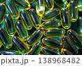 Omega 3 fish oil capsules close up on green background, glossy softgel supplements, healthcare and wellness concept 138968482