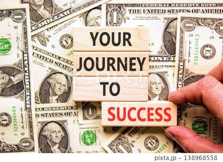 Your journey to success symbol. Concept words Your journey to success on beautiful wooden blocks. Beautiful dollar bills background. Business motivational your journey to success concept. Copy space. Your journey to success symbol. Concept words Your journey to success on beautiful wooden blocks. Beautiful dollar bills background. Business motivational your journey to success concept. Copy space. 138968558