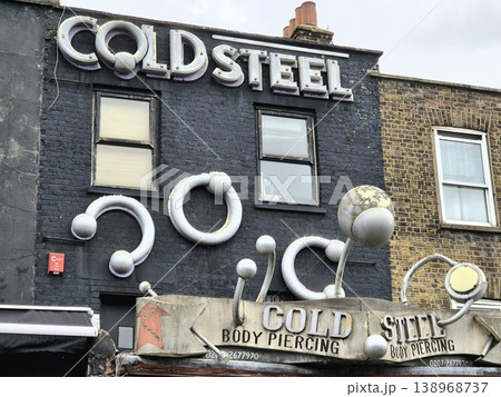 London UK 05.07.2025 Cold Steel body piercing shop facade with large industrial ring sculptures on building exterior in Camden showcasing bold design and alternative urban culture atmosphere 138968737