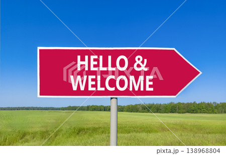 Hello and welcome symbol. Concept words Hello and welcome on beautiful red road sign. Beautiful blue sky green grass field background. Business hello and welcome concept. Copy space. Hello and welcome symbol. Concept words Hello and welcome on beautiful red road sign. Beautiful blue sky green grass field background. Business hello and welcome concept. Copy space. 138968804