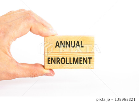 Annual enrollment words symbol. Concept words Annual enrollment on beautiful wooden blocks. Beautiful white background. Doctor hand. Medical and Annual enrollment words concept. Copy space. 138968821