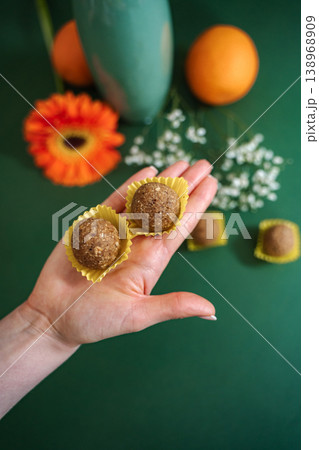 Woman's hand holding homemade energy balls Woman's hand holding homemade energy balls 138968909