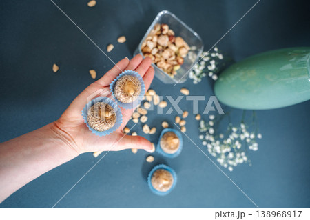 Hand holding homemade healthy energy balls with nuts Hand holding homemade healthy energy balls with nuts 138968917