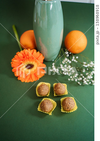 Healthy energy balls with fresh oranges and vibrant gerbera flower Healthy energy balls with fresh oranges and vibrant gerbera flower 138968918