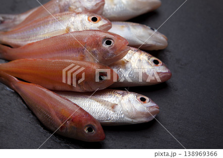 Fresh Red Coral Fish on Granite Surface Fresh Red Coral Fish on Granite Surface 138969366