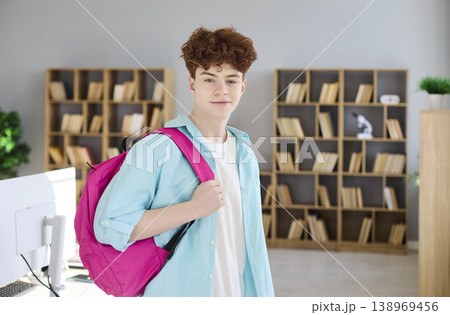 Confident teen student with backpack in bright library, ready for study and school Confident teen student with backpack in bright library, ready for study and school 138969456