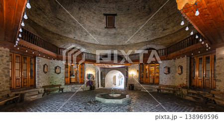 Historic Upper Caravanserai interior with fountain, brick dome, and wooden balcony, Shaki, Azerbaijan Historic Upper Caravanserai interior with fountain, brick dome, and wooden balcony, Shaki, Azerbaijan 138969596