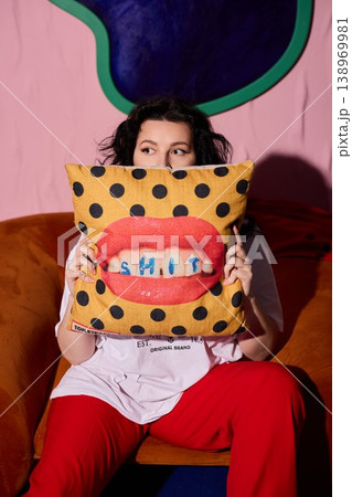 Intimate image capturing woman with embroidered pillow accessory Intimate image capturing woman with embroidered pillow accessory 138969981