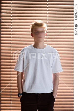 Portrait of young individual under streaked lighting effects Portrait of young individual under streaked lighting effects 138970025