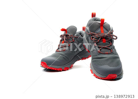 Men trekking shoes isolated on white background. Gray-red hiking shoes. Safety footwear for climbing. Adventure gear. Lightweight rubber trekking shoes with safety sole. Modern and breathable design. Men trekking shoes isolated on white background. Gray-red hiking shoes. Safety footwear for climbing. Adventure gear. Lightweight rubber trekking shoes with safety sole. Modern and breathable design. 138972913