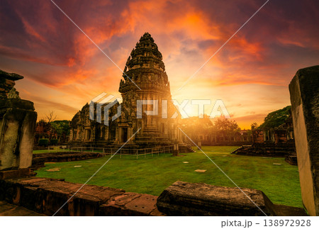 Selective focus on Phimai Historical Park with sunset sky. Landmark of Nakhon Ratchasima, Thailand. Travel destinations. Historic site is ancient. Ancient building. Khmer temple classical architecture Selective focus on Phimai Historical Park with sunset sky. Landmark of Nakhon Ratchasima, Thailand. Travel destinations. Historic site is ancient. Ancient building. Khmer temple classical architecture 138972928