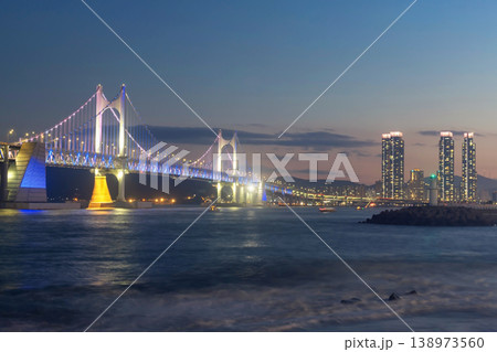 Gwangan Bridge light up against skyscraper and motion wave at dusk, Busan Gwangan Bridge light up against skyscraper and motion wave at dusk, Busan 138973560