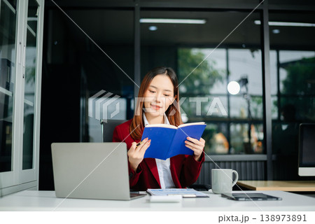 Portrait of a young women sitting at his desk in the office. Portrait of a young women sitting at his desk in the office. 138973891