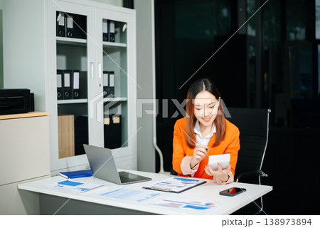 Portrait of a young women sitting at his desk in the office. 138973894