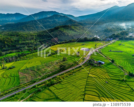 Beautiful morning view in Indonesia, panoramic landscape of rice fields with mountain ranges and clear sky Beautiful morning view in Indonesia, panoramic landscape of rice fields with mountain ranges and clear sky 138975539