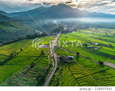 Beautiful morning view in Indonesia, panoramic landscape of rice fields with mountain ranges and clear sky Beautiful morning view in Indonesia, panoramic landscape of rice fields with mountain ranges and clear sky 138975541