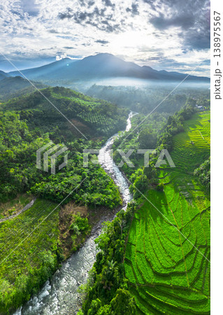 Beautiful morning view in Indonesia, panoramic landscape of rice fields with mountain ranges and clear sky Beautiful morning view in Indonesia, panoramic landscape of rice fields with mountain ranges and clear sky 138975567