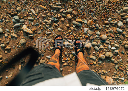 Point of View Looking Down at Feet in Sandals on a Rocky Beach Point of View Looking Down at Feet in Sandals on a Rocky Beach 138976072