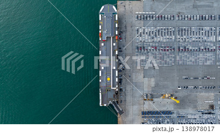 Aerial view cargo vehicles car carrier at import export cars terminal seaport, Vehicle car carrier vessel loading cars for shipping to worldwide, Automotive industry distribution logistic transport 138978017