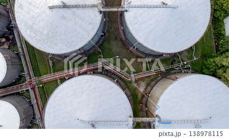 Aerial view white oil storage tank with pipeline steel, Crude oil industry, Storage fuel gas container tank petroleum refinery industrial factory, Oil storage chemical petrochemical refinery product. Aerial view white oil storage tank with pipeline steel, Crude oil industry, Storage fuel gas container tank petroleum refinery industrial factory, Oil storage chemical petrochemical refinery product. 138978115