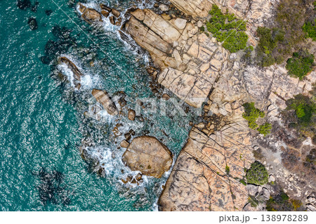 Aerial view of Rose Bay in Bowen, Queensland, Australia. The scene shows a tropical coastal landscape with clear blue water, sandy shoreline and surrounding natural environment. Aerial view of Rose Bay in Bowen, Queensland, Australia. The scene shows a tropical coastal landscape with clear blue water, sandy shoreline and surrounding natural environment. 138978289