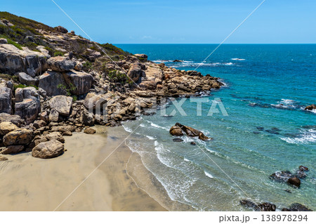 Aerial view of Rose Bay in Bowen, Queensland, Australia. The scene shows a tropical coastal landscape with clear blue water, sandy shoreline and surrounding natural environment. Aerial view of Rose Bay in Bowen, Queensland, Australia. The scene shows a tropical coastal landscape with clear blue water, sandy shoreline and surrounding natural environment. 138978294