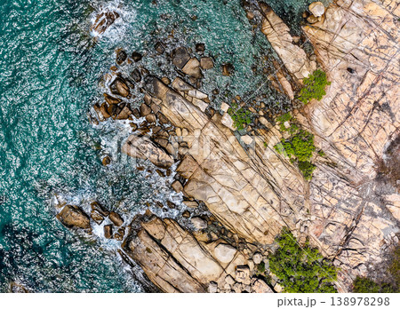 Aerial view of Rose Bay in Bowen, Queensland, Australia. The scene shows a tropical coastal landscape with clear blue water, sandy shoreline and surrounding natural environment. 138978298