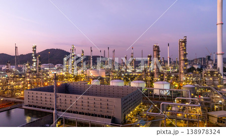 Aerial view oil and gas industrial refinery at twilight, Oil refinery and Petrochemical plant pipeline steel, Refinery factory oil storage tank and pipeline steel at night. Aerial view oil and gas industrial refinery at twilight, Oil refinery and Petrochemical plant pipeline steel, Refinery factory oil storage tank and pipeline steel at night. 138978324