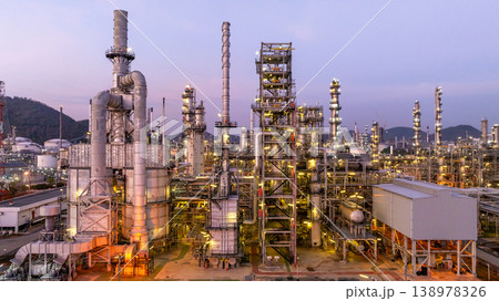 Aerial view oil and gas industrial refinery at twilight, Oil refinery and Petrochemical plant pipeline steel, Refinery factory oil storage tank and pipeline steel at night. 138978326