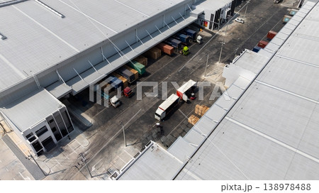 Aerial view modern warehouse for trucks unloading and loading, semi truck cargo trailer at logistic park warehouse, Distribution warehouse shipping supply chain, Business transportation logistic. 138978488