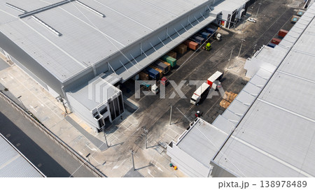 Aerial view modern warehouse for trucks unloading and loading, semi truck cargo trailer at logistic park warehouse, Distribution warehouse shipping supply chain, Business transportation logistic. Aerial view modern warehouse for trucks unloading and loading, semi truck cargo trailer at logistic park warehouse, Distribution warehouse shipping supply chain, Business transportation logistic. 138978489
