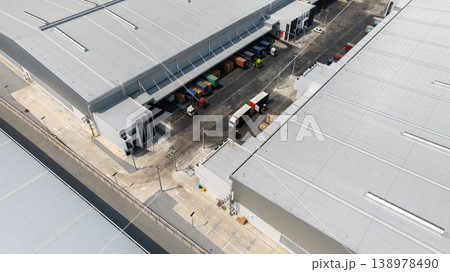 Aerial view modern warehouse for trucks unloading and loading, semi truck cargo trailer at logistic park warehouse, Distribution warehouse shipping supply chain, Business transportation logistic. Aerial view modern warehouse for trucks unloading and loading, semi truck cargo trailer at logistic park warehouse, Distribution warehouse shipping supply chain, Business transportation logistic. 138978490