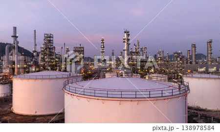 Aerial view oil and gas petrochemical storage tank with oil and gas refinery plant at twilight, Global business power and energy petrochemical industry, Oil and gas refinery petrochemical industrial. 138978584